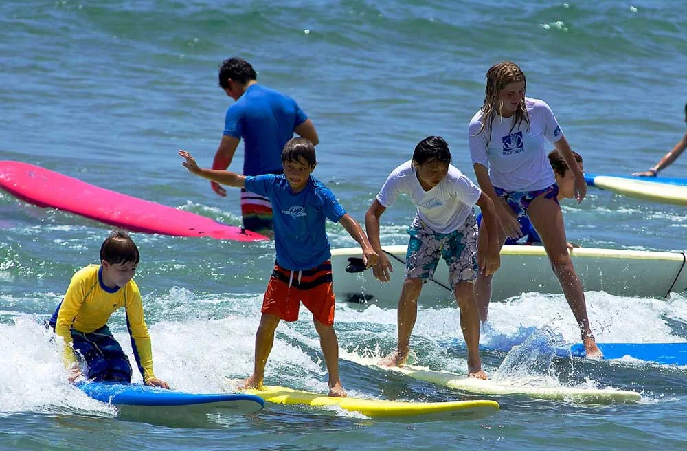Kids learning to surf at Blue Water Surf Camp