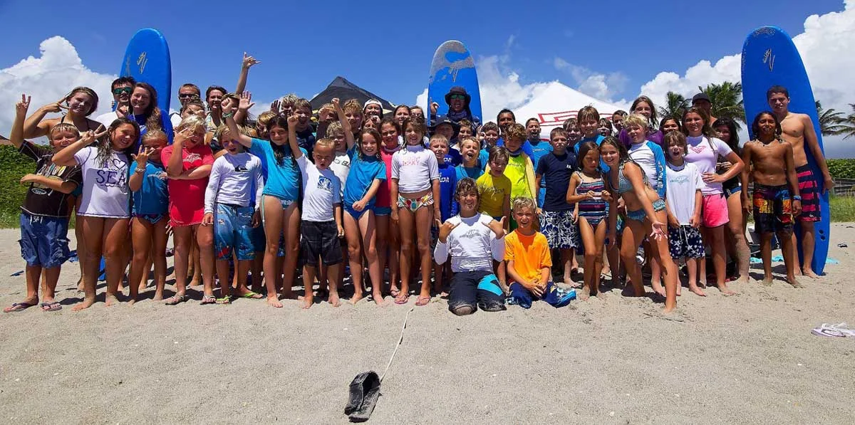 Happy kids surfing at Blue Water Summer Surf Camp